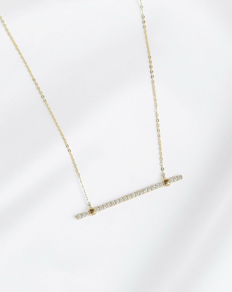 Enter to Win a Stunning 14K Yellow Gold Bar Pendant and Gift a PaperCity Ad Package to One Non-Profit Organization From Diamonds Direct.